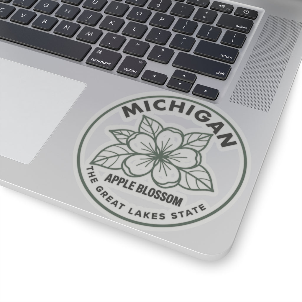 Circular Michigan apple blossom transparent vinyl sticker on laptop, gray floral logo seal