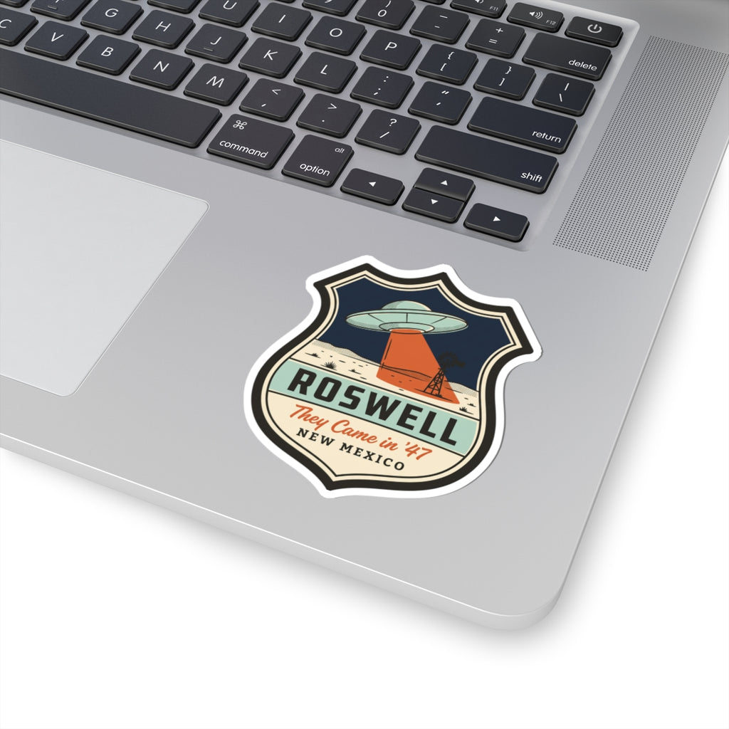 Shield badge kiss-cut sticker with UFO, orange base, and bold “ROSwell” lettering