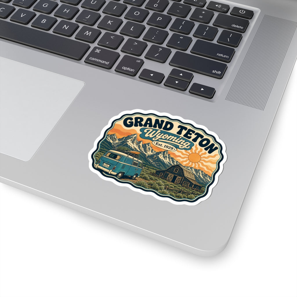 Grand Teton Wyoming sticker design: teal camper van, barn, mountain range, and orange sun