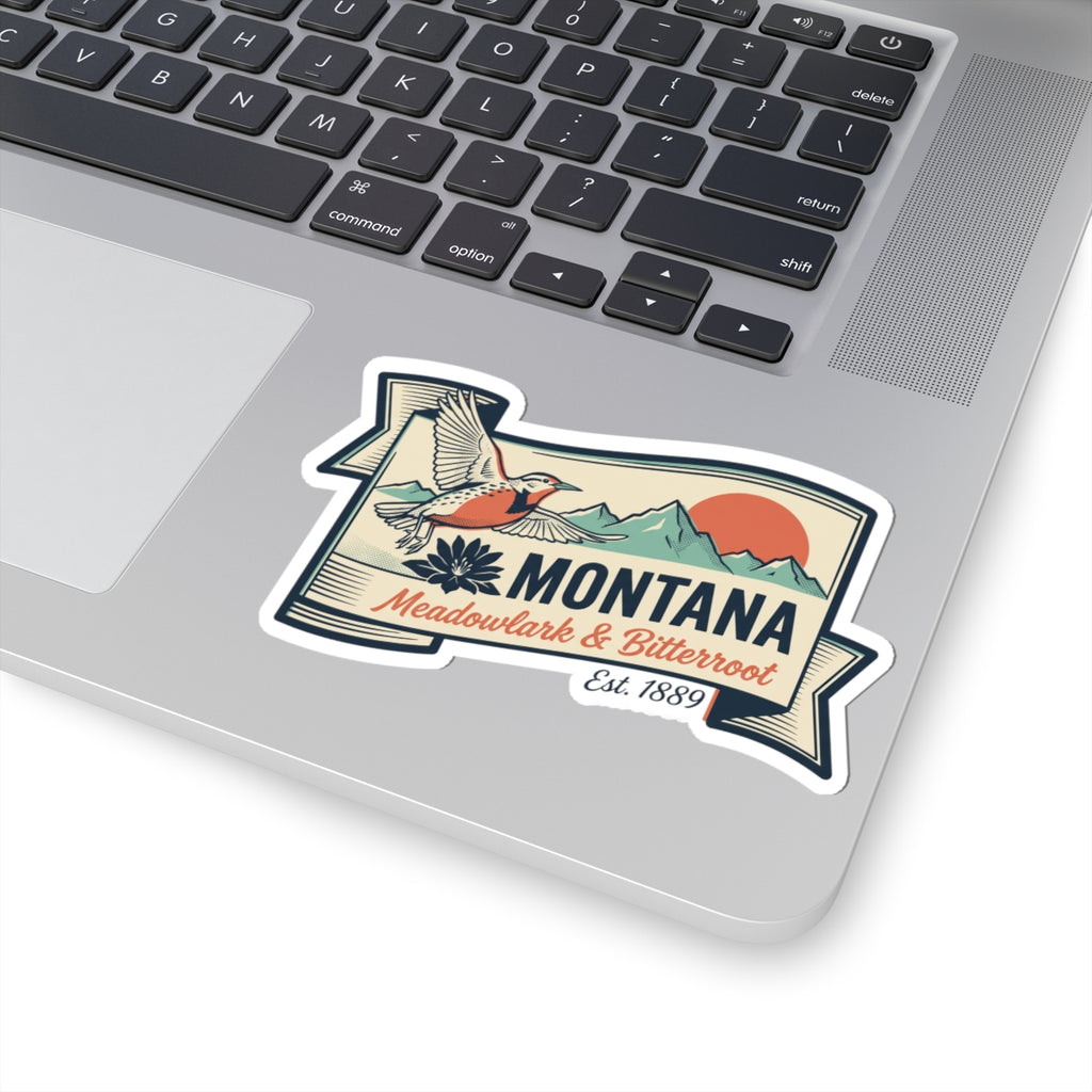 Montana state badge vinyl sticker on laptop, showing bird, flowers, and banner