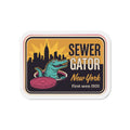 Die-cut refrigerator magnet with rounded white border, Sewer Gator New York artwork.