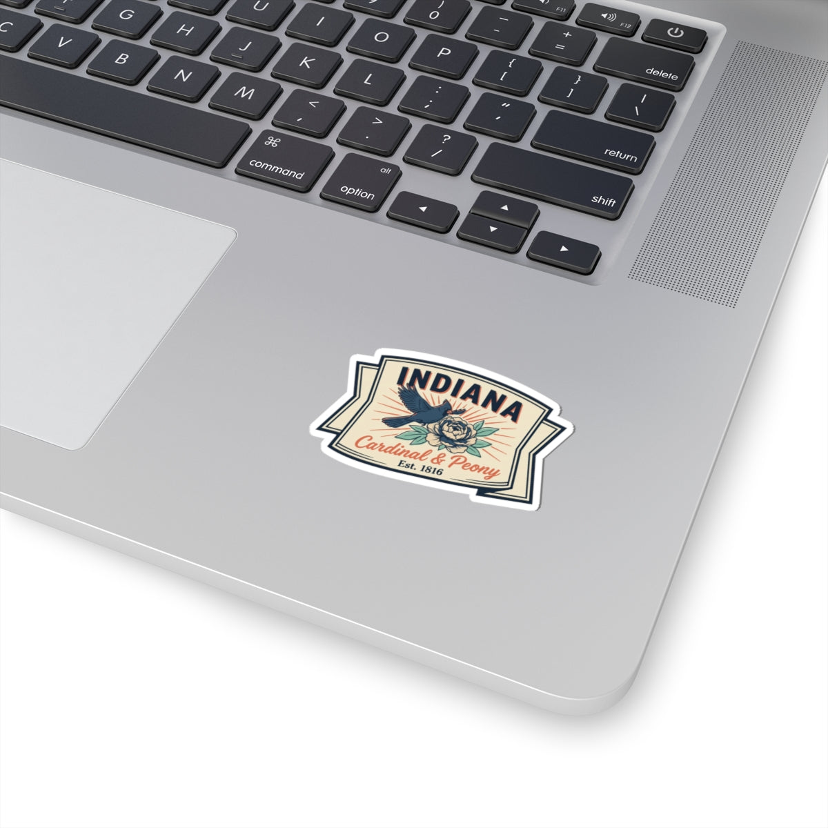Vintage Indiana state badge vinyl sticker with cardinal and peony, on white laptop