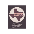 Mauve metal wall art with Texas silhouette, star, and “Texas” script in a circular design