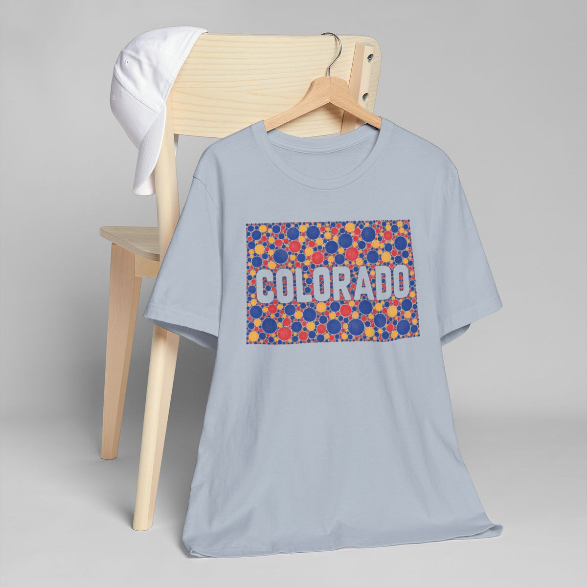 Light blue Colorado graphic t-shirt with colorful patterned rectangle and Colorado lettering