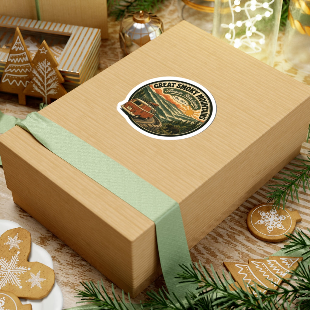 Round holiday sticker on a gift box: vintage camper van in mountain and pine scenery