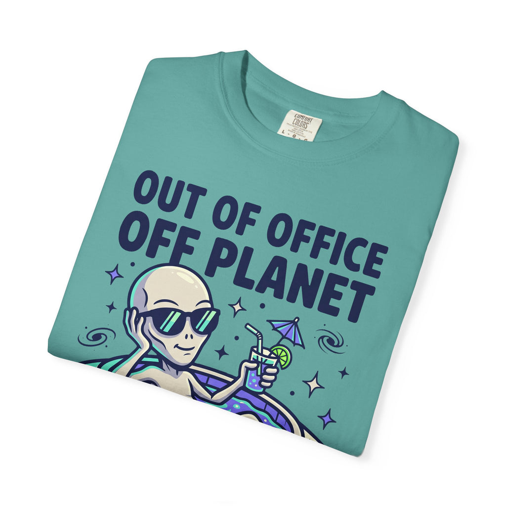 Teal T-shirt with “Out of Office Off Planet” alien floatie graphic on front