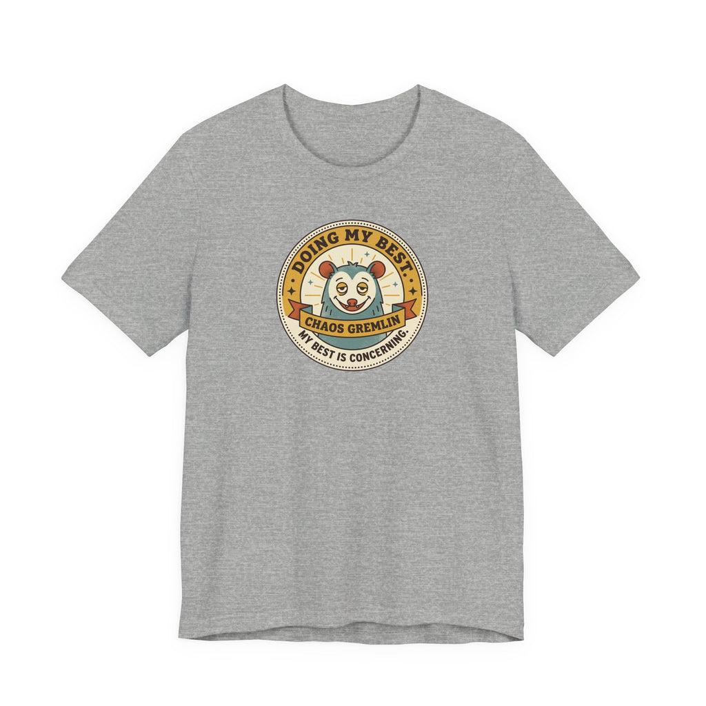 Dark gray T-shirt with round gremlin badge graphic on center chest