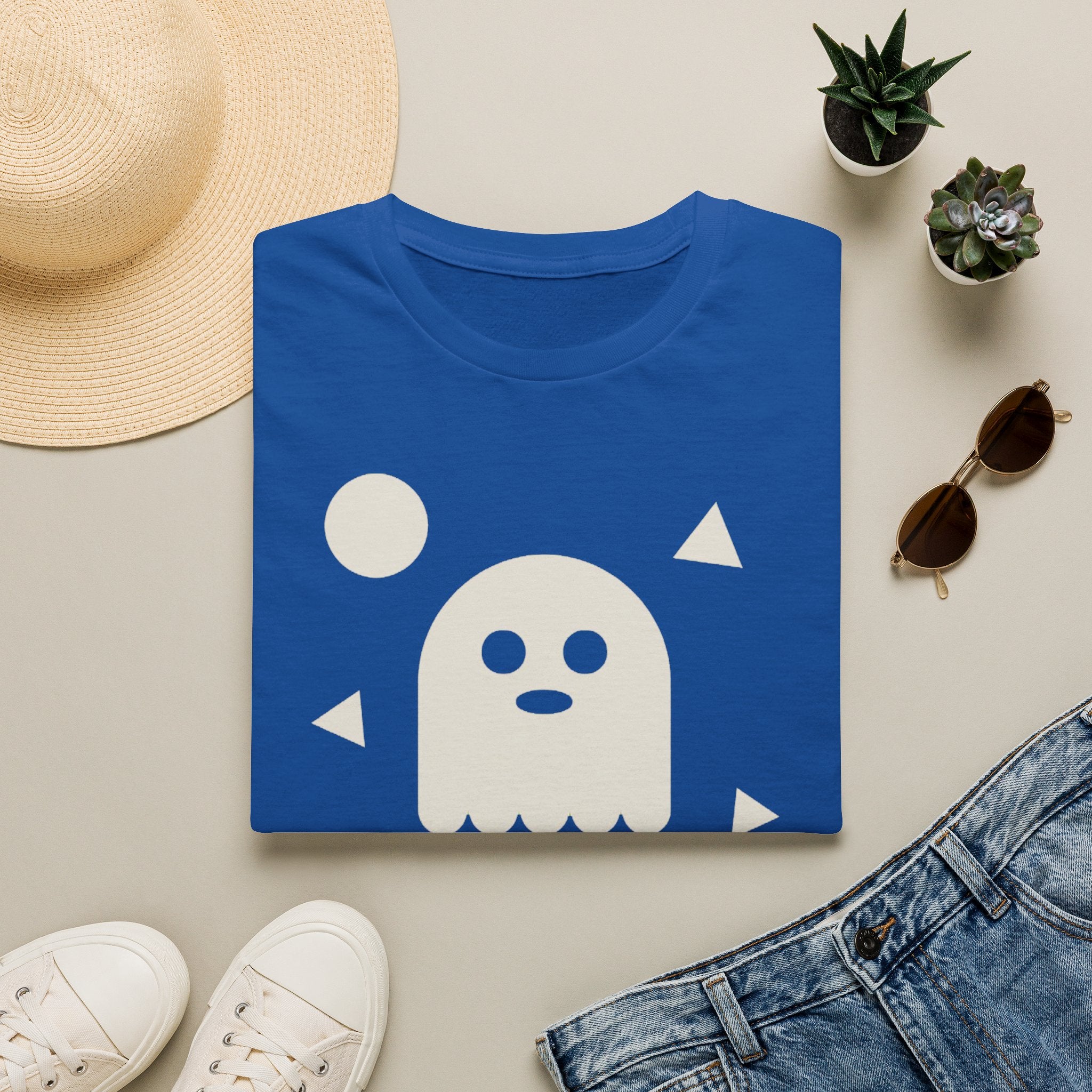 Royal blue T-shirt with white ghost face graphic and small triangle accents