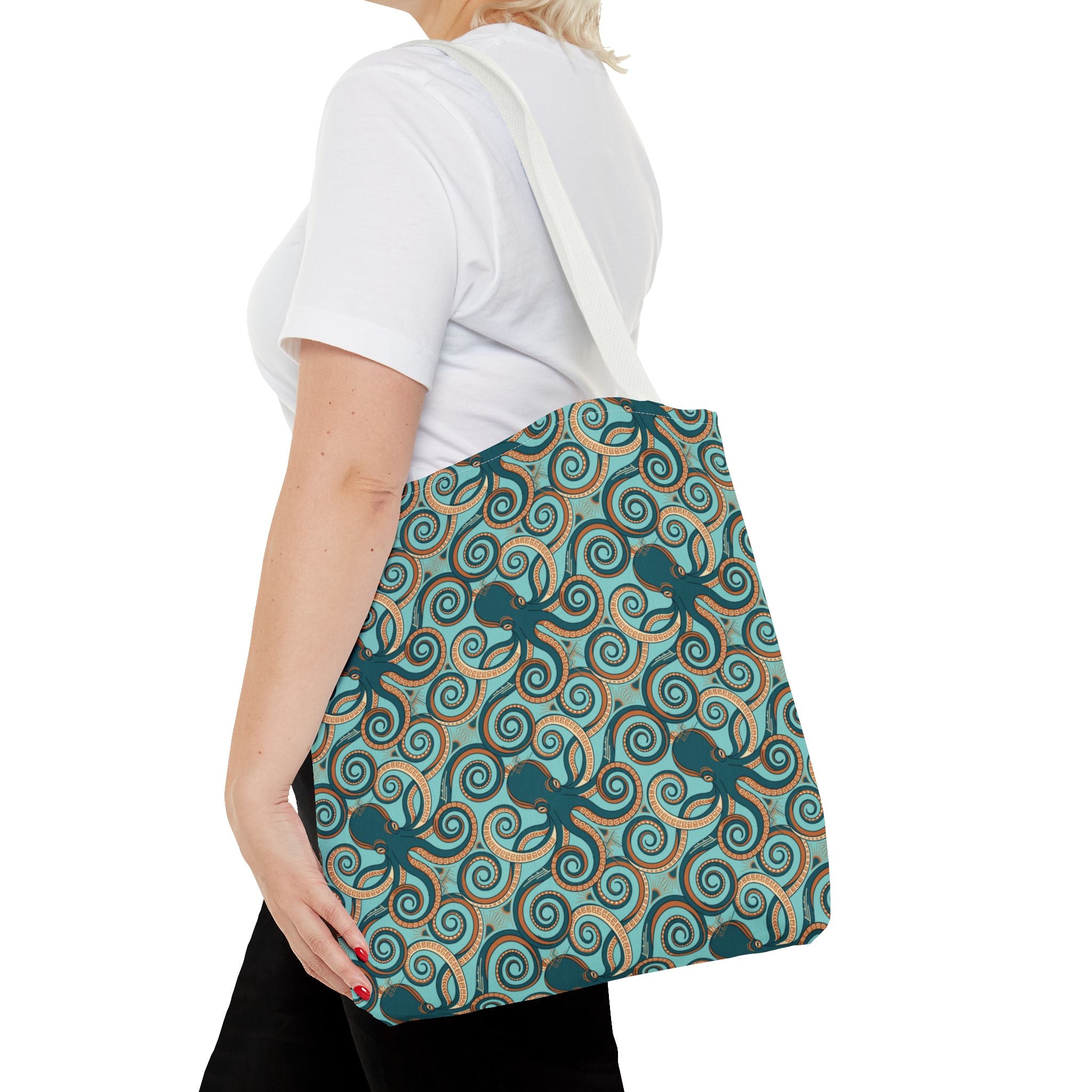 Octopus swirl tote bag worn crossbody; teal all-over octopus swirl pattern.