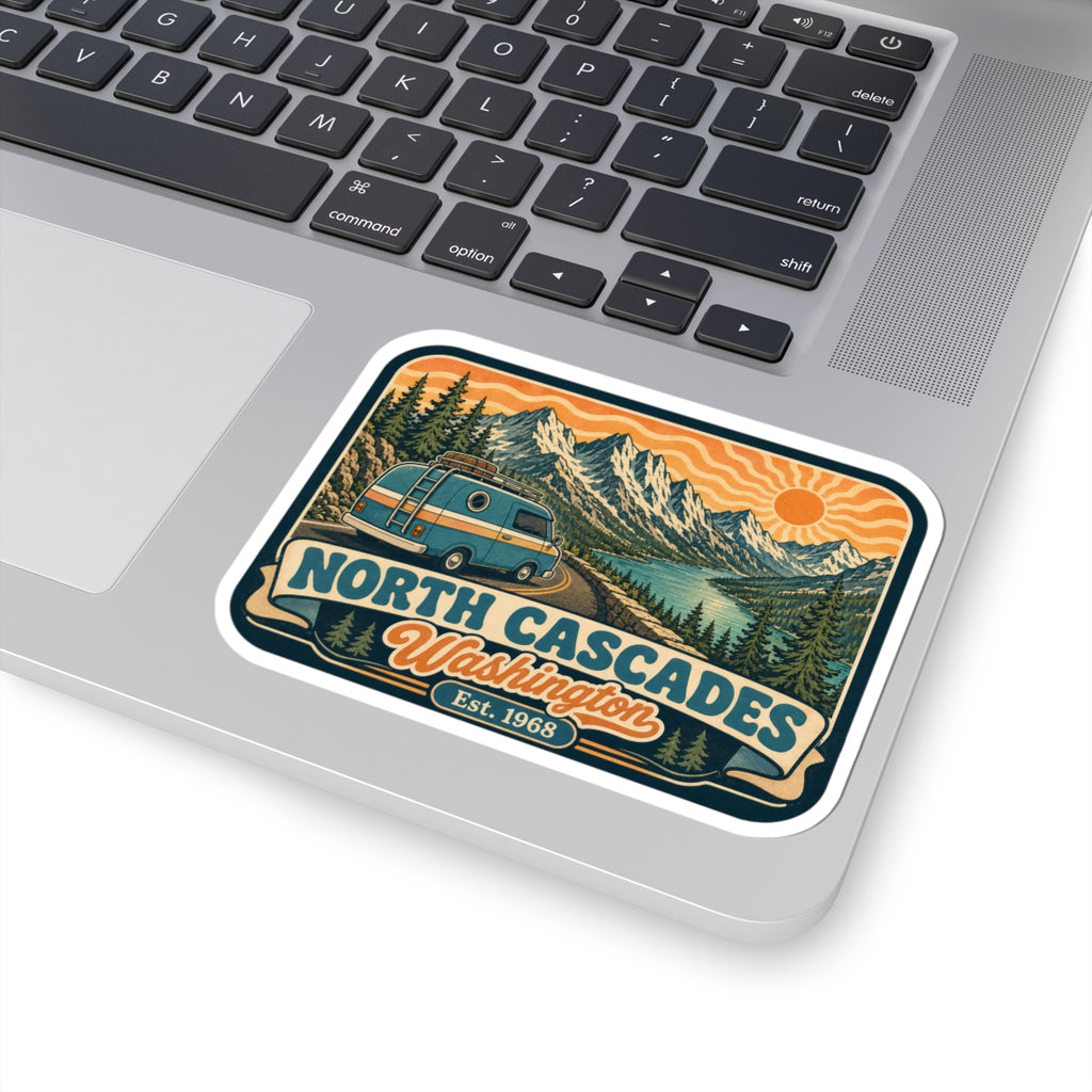 Vintage park travel sticker on laptop trackpad area with blue van, mountains, pine trees