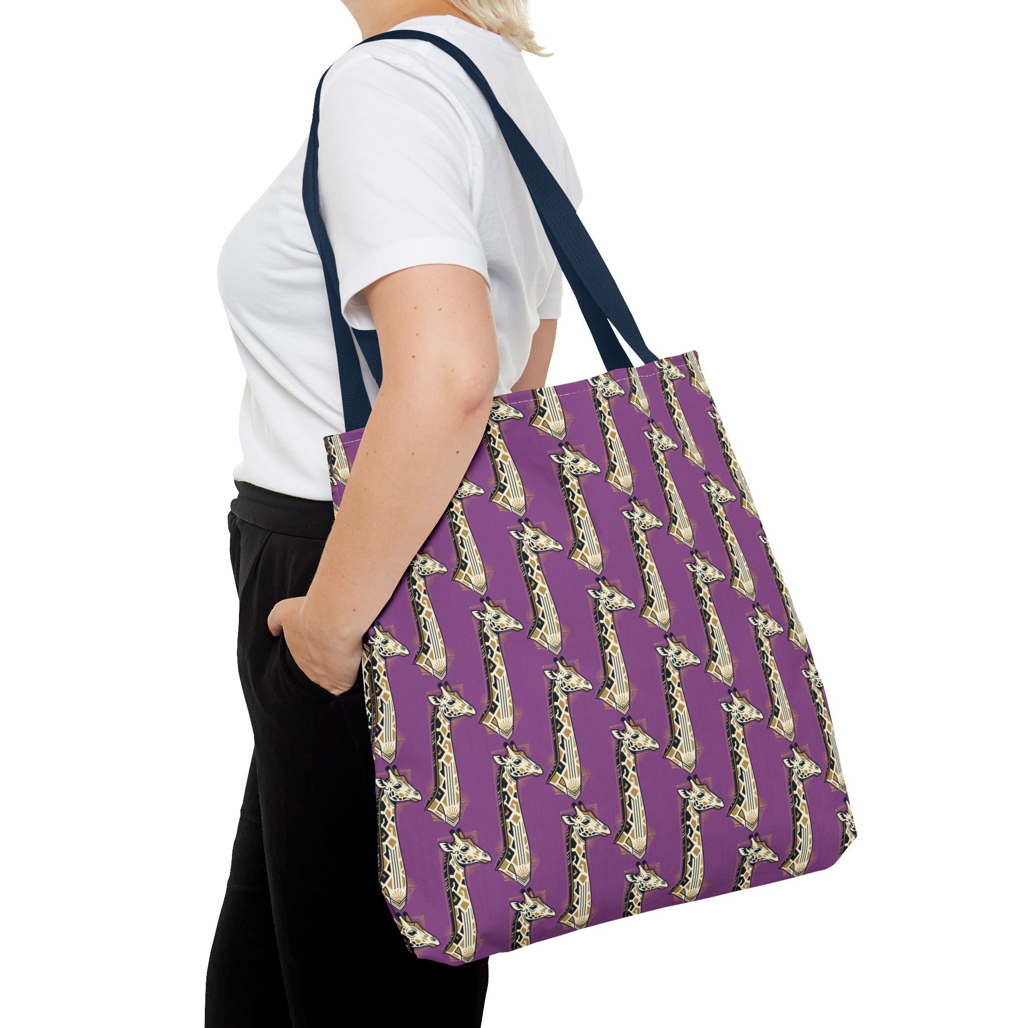 Purple tote bag with repeating saxophone pattern and navy handles, side view on shoulder.