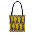Tote bag with yellow cat pattern, blue-and-black cat faces, black top handles.