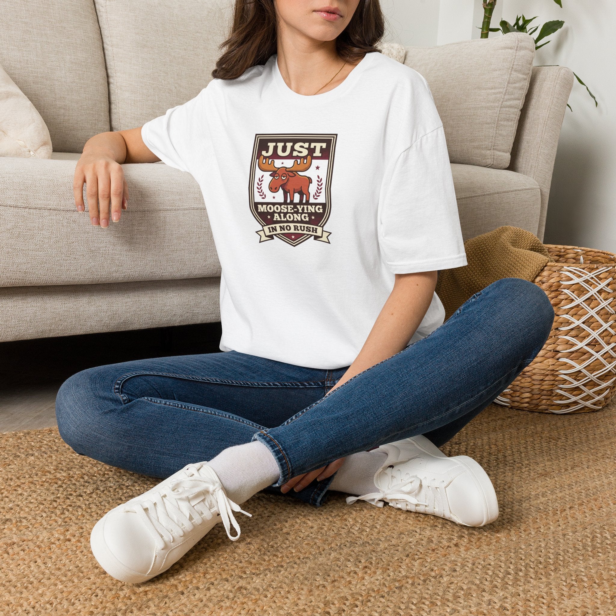 White crewneck T-shirt worn by model with “Just Moose-ying Along” moose graphic