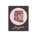Mauve metal wall art with circular desert silhouette and cursive 'Arizona' text