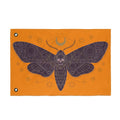 Orange gothic moth skull flag with purple wings and centered skull, metal grommets.