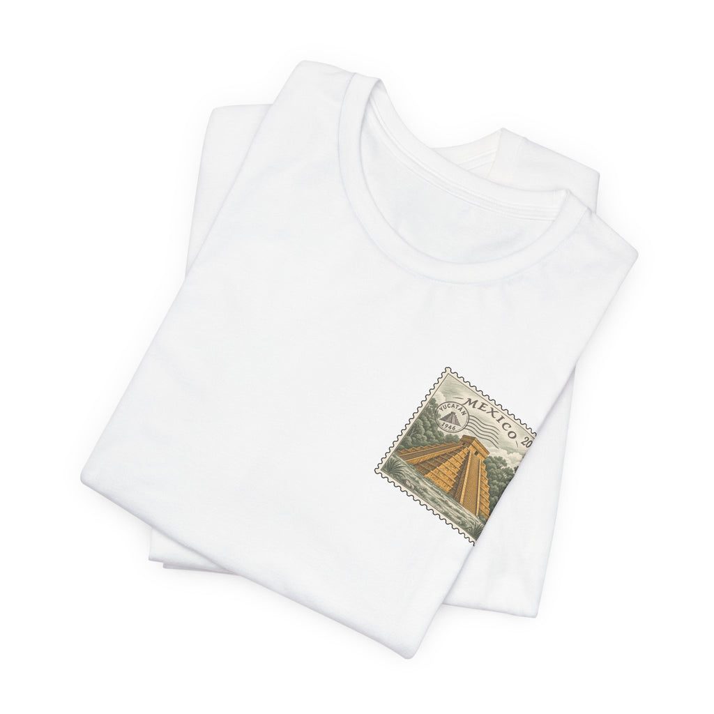 White crew-neck t-shirt set with small vintage Mexico postage-stamp graphic on chest.