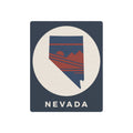 Nevada retro badge metal sign with blue background, Nevada text, and desert stripe graphic