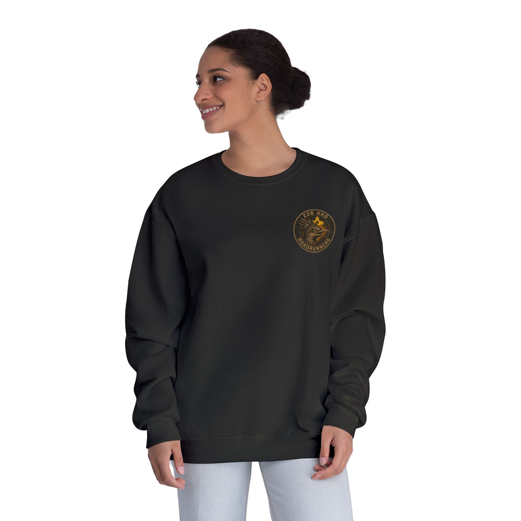 Black crewneck sweatshirt on model, side view with front patch emblem