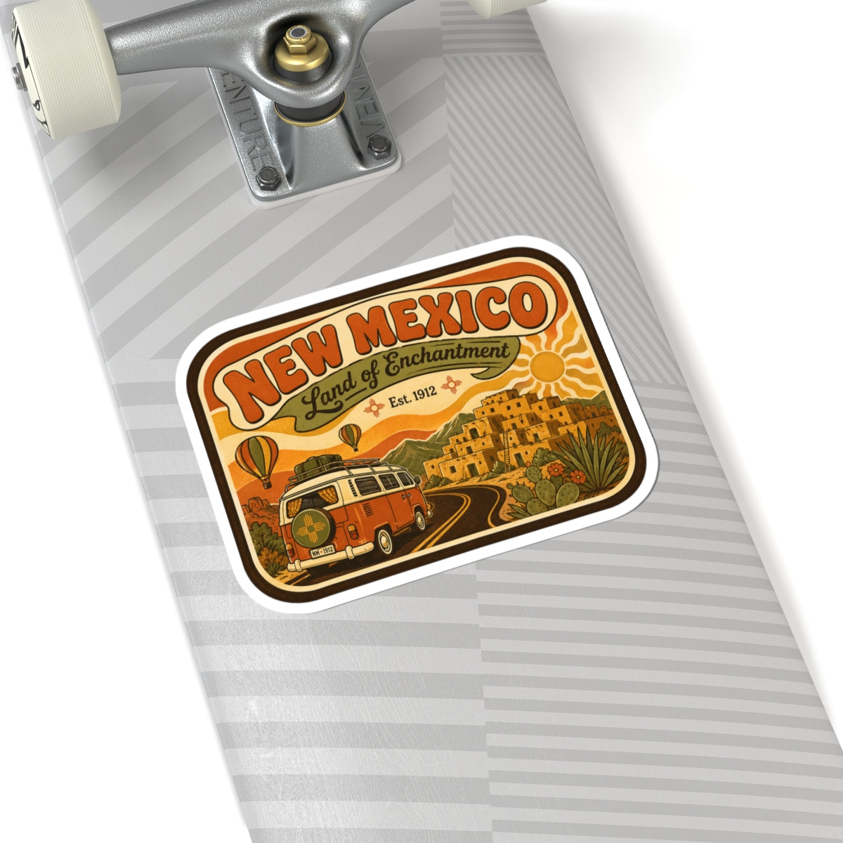 Die-cut New Mexico sticker with vintage orange camper, desert landscape, and “Land of Enchantment”