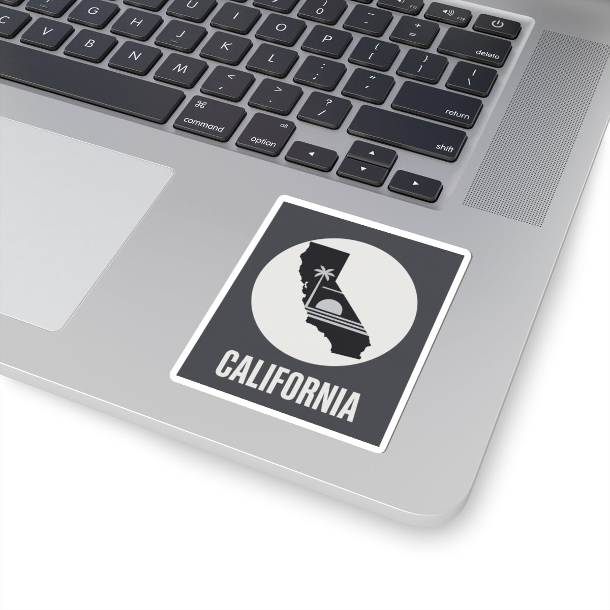 California state silhouette sticker with palm tree icon and CALIFORNIA text on laptop surface