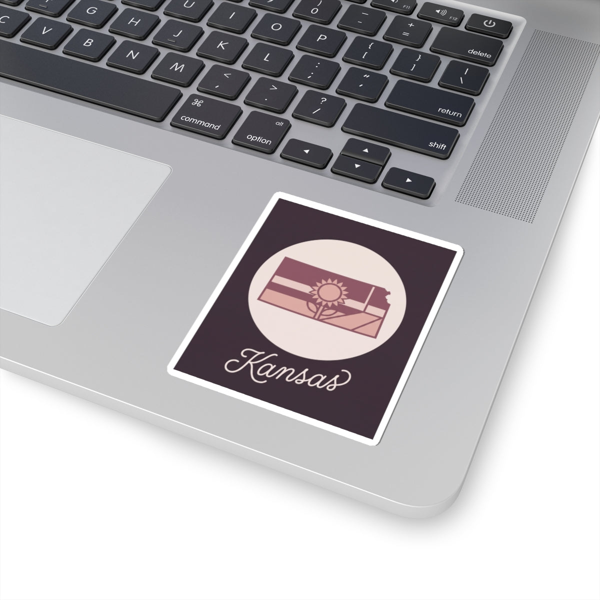 Kansas mauve kiss-cut vinyl decal sticker with state silhouette, sun icon, and “Kansas” script