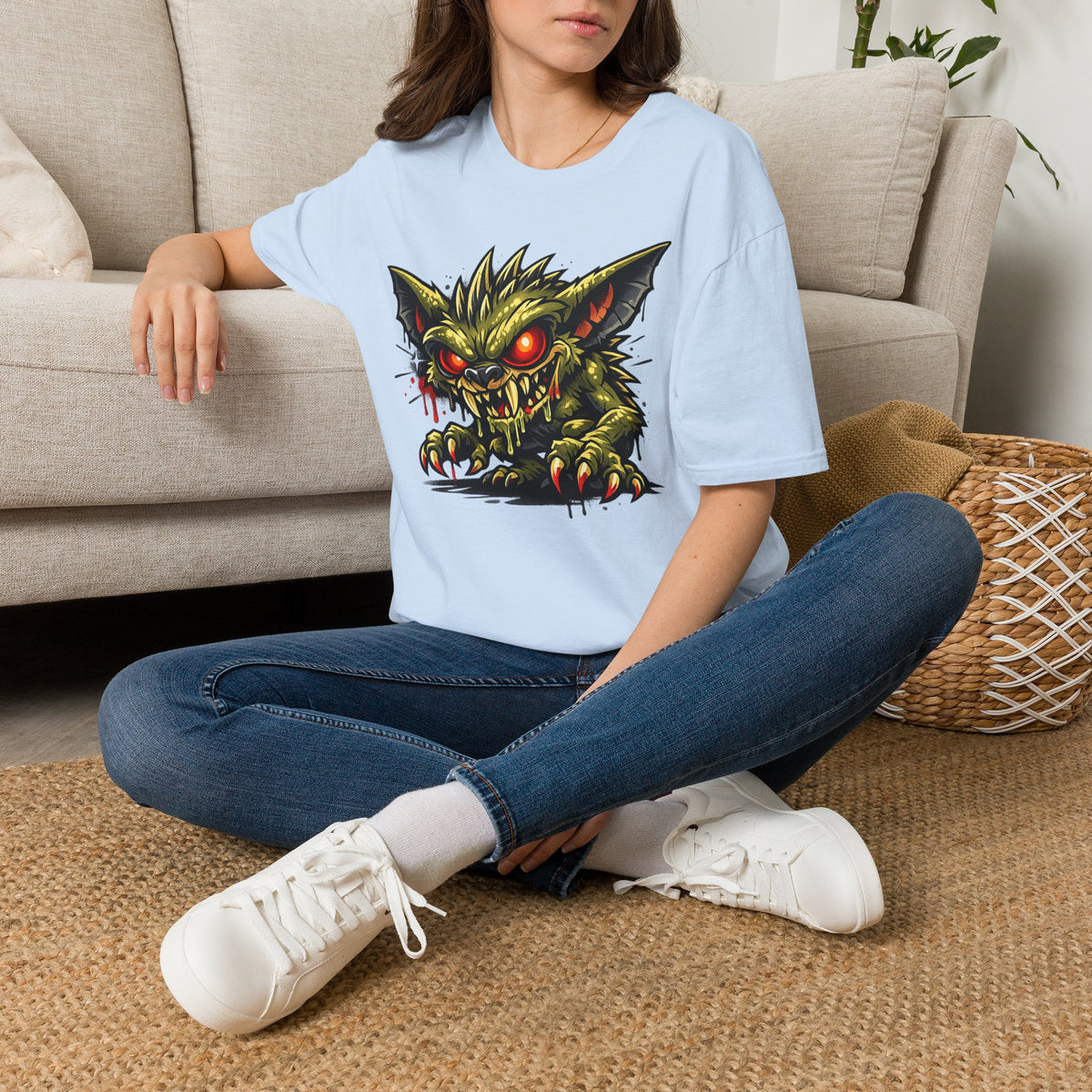 Light blue horror graphic T-shirt with green gremlin skull and red glowing eyes front print