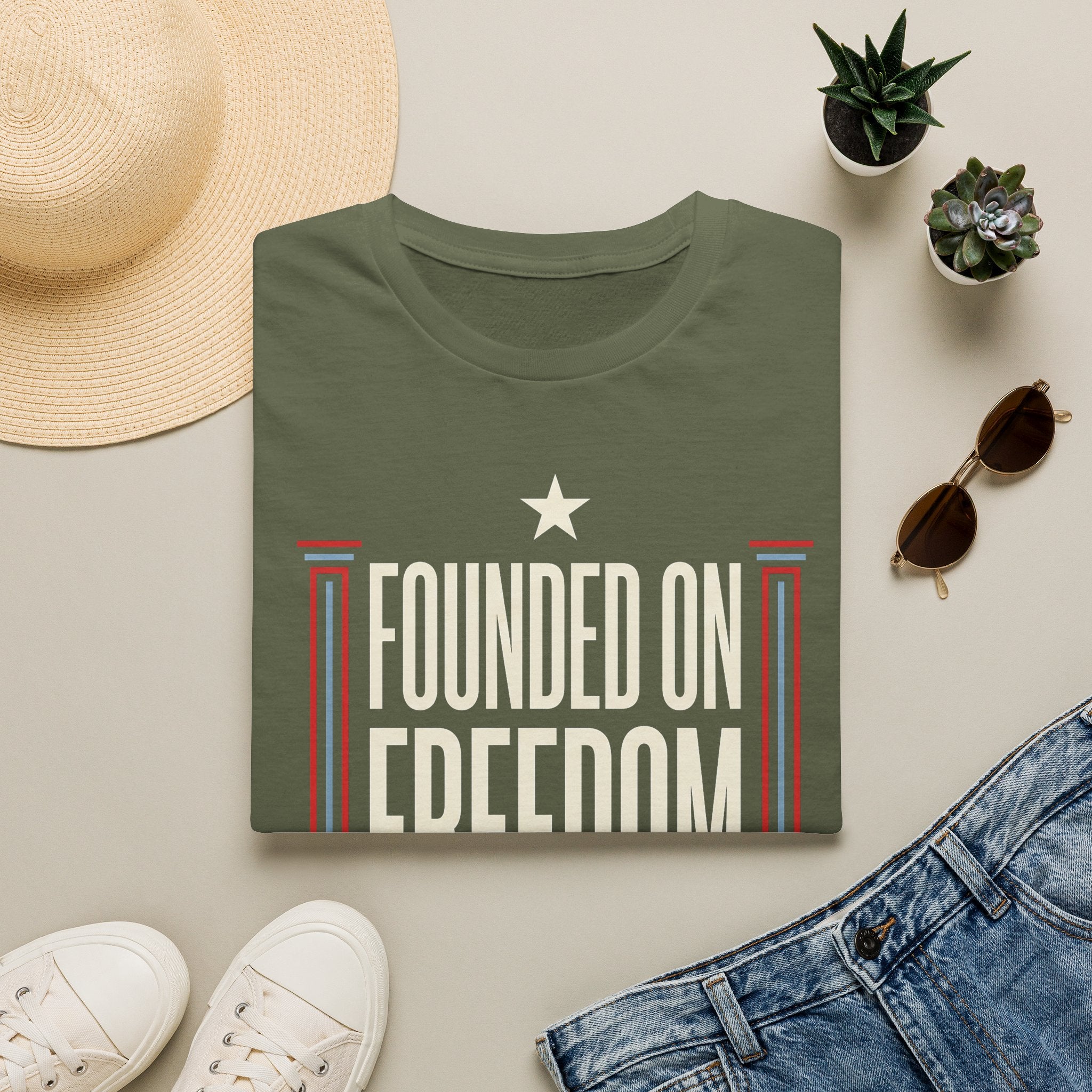 Green short-sleeve t-shirt with white star and "Founded on Freedom" graphic