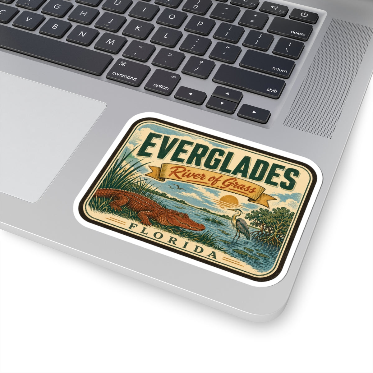 Everglades River of Grass Florida travel sticker on a laptop keyboard, angled view.