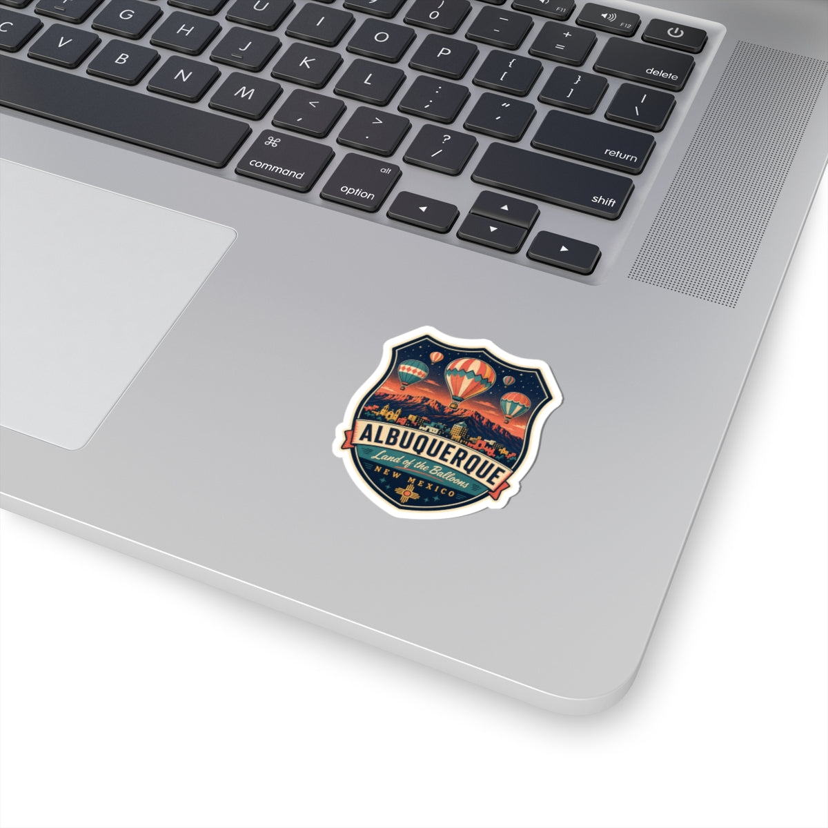 Luggage tag sticker with Albuquerque badge and hot air balloons over desert mountains