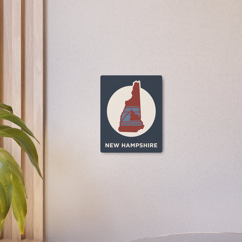 New Hampshire metal art sign on wall, dark blue square with red state emblem and “NEW HAMPSHIRE”