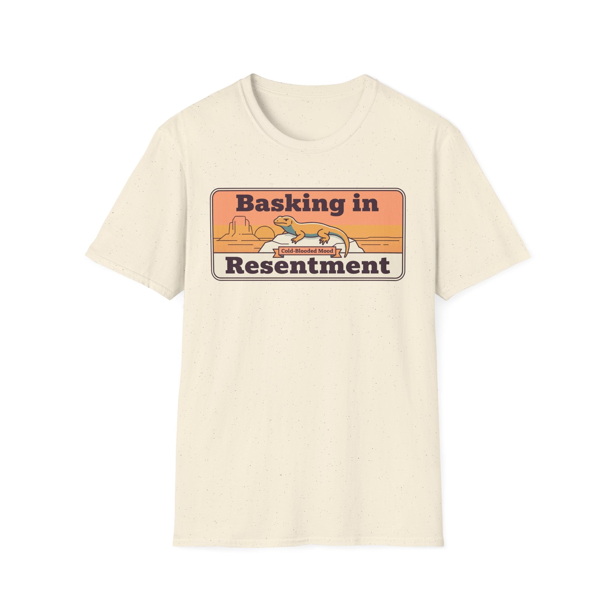 Cream crew-neck T-shirt with “Basking in Resentment” desert lizard graphic.
