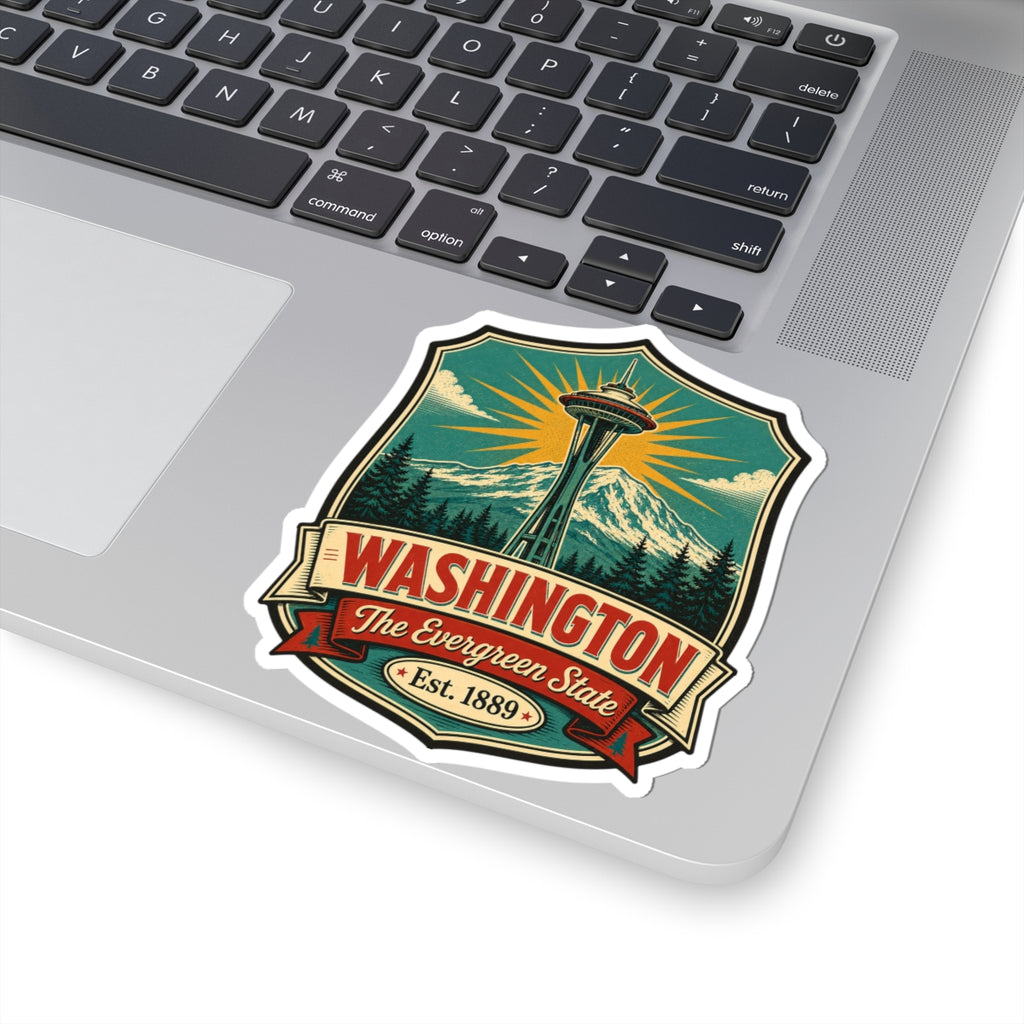 Washington State vinyl decal sticker on laptop lid, shield artwork with Space Needle, mountains, and trees