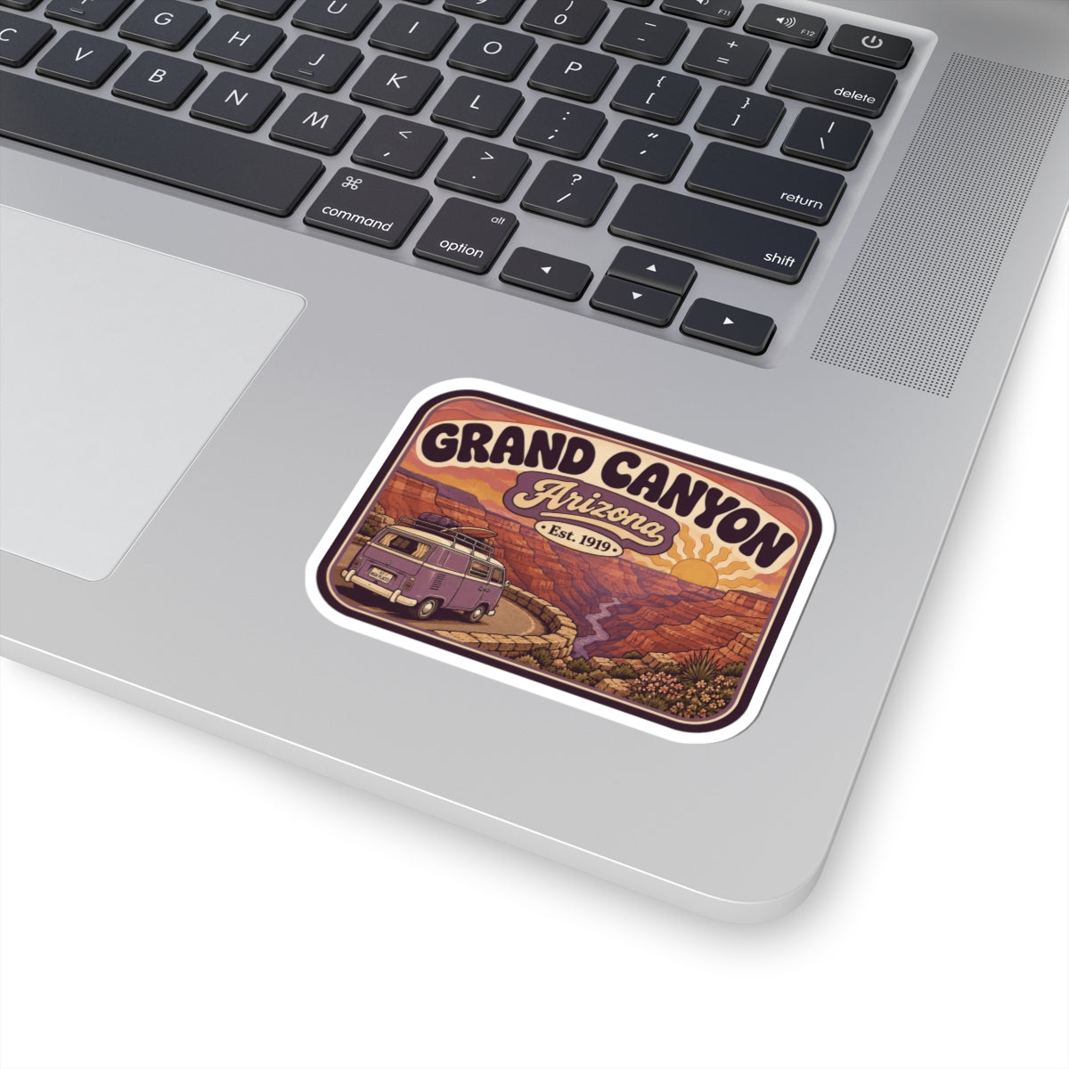 Rounded Grand Canyon sticker on laptop lid with purple camper van and "Arizona"