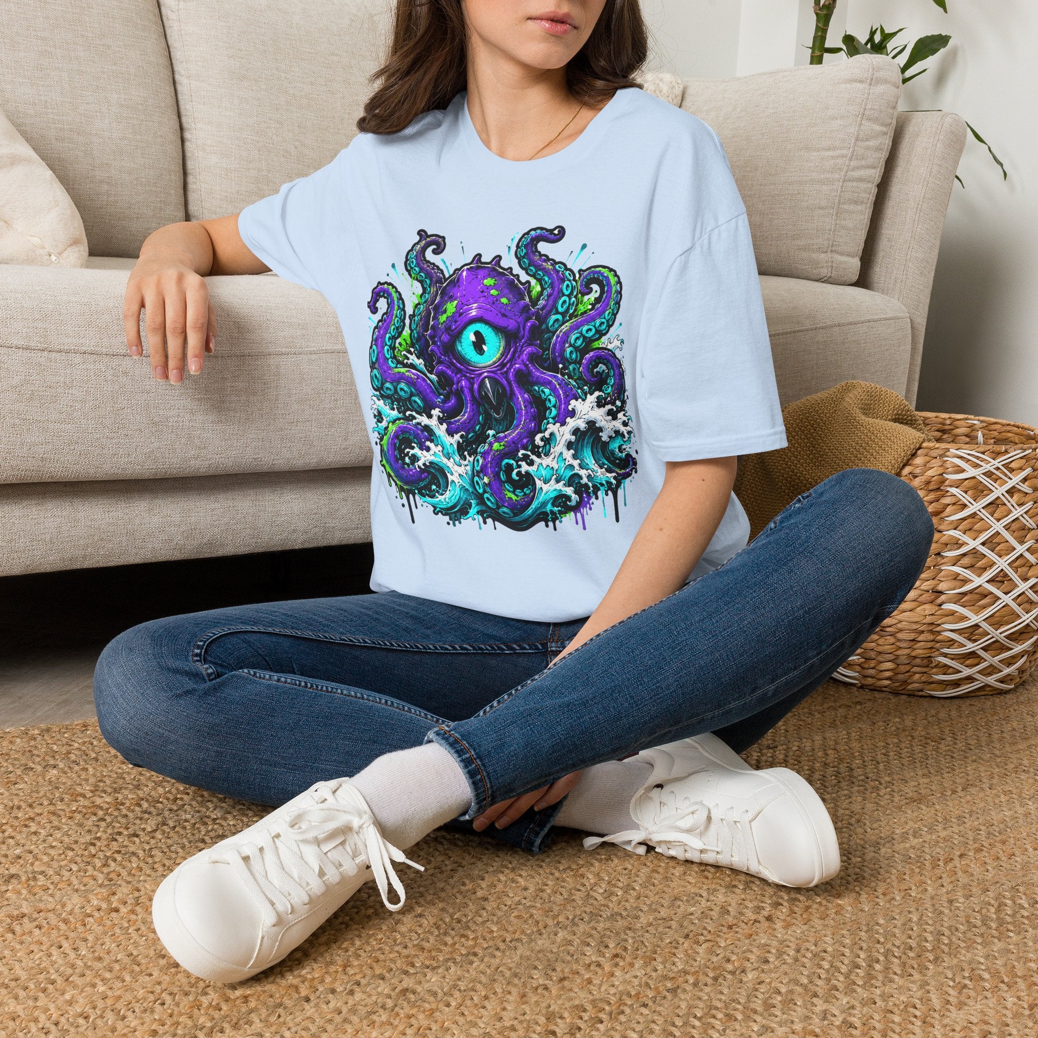 Light blue graphic octopus monster T-shirt with purple eye and teal tentacles