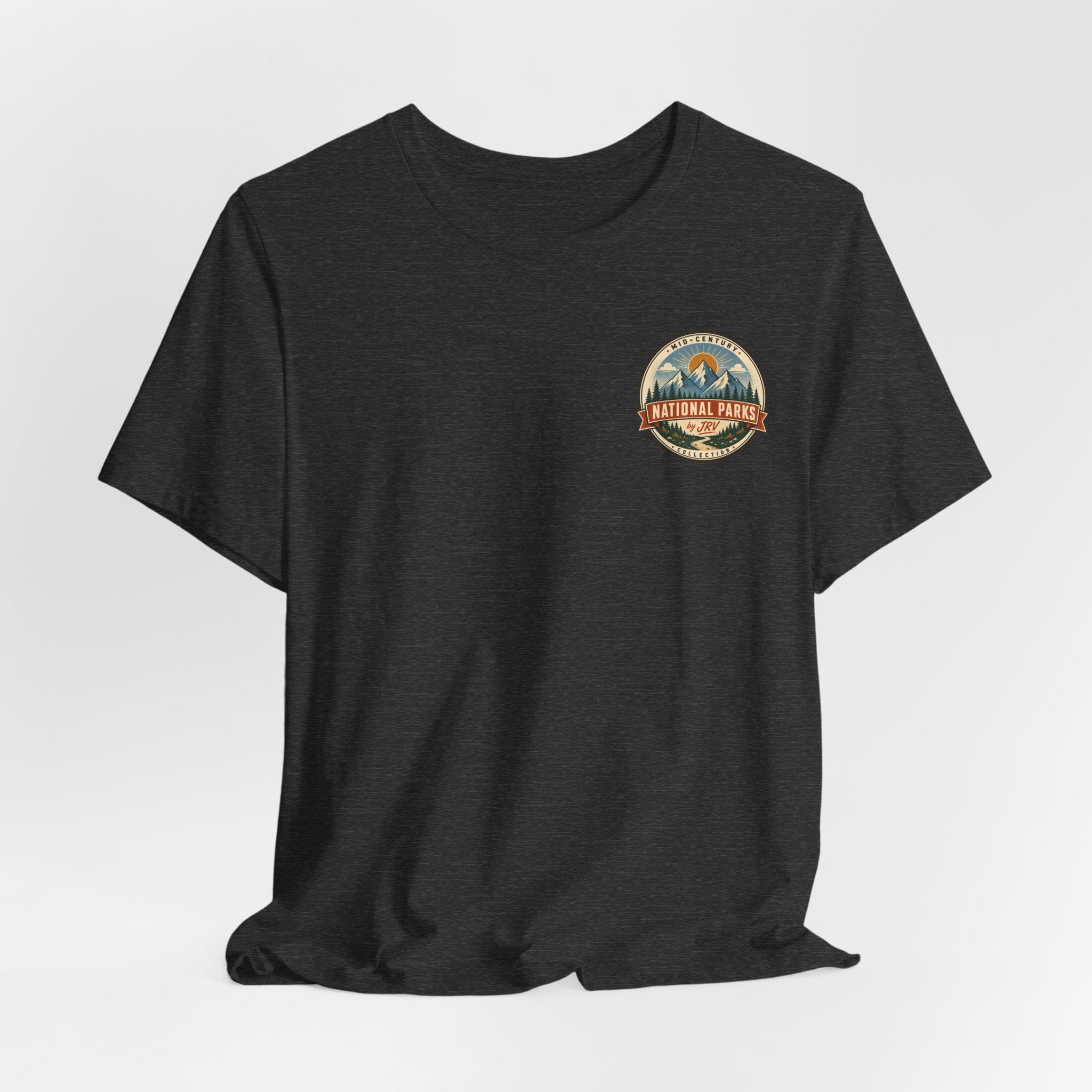 Charcoal dark t-shirt on model, small round National Park patch logo at the chest.
