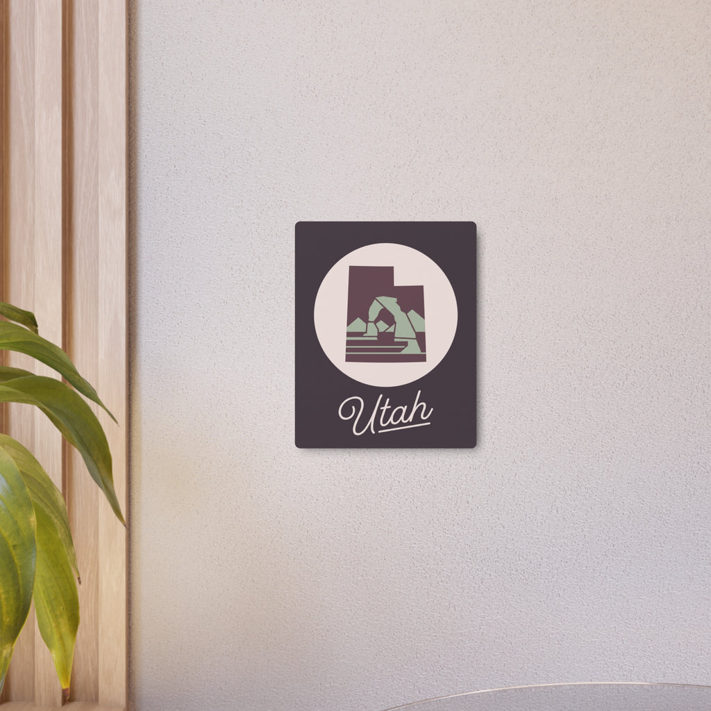 Dark square metal wall art with circular Utah silhouette and “Utah” wordmark