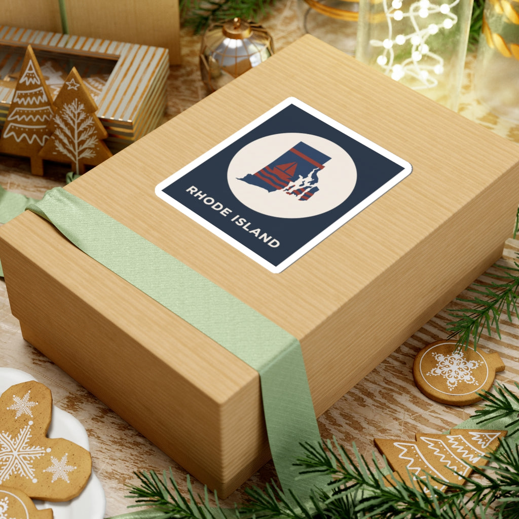 Rhode Island sticker on a gift box, dark blue label with white circle and sailboat graphic