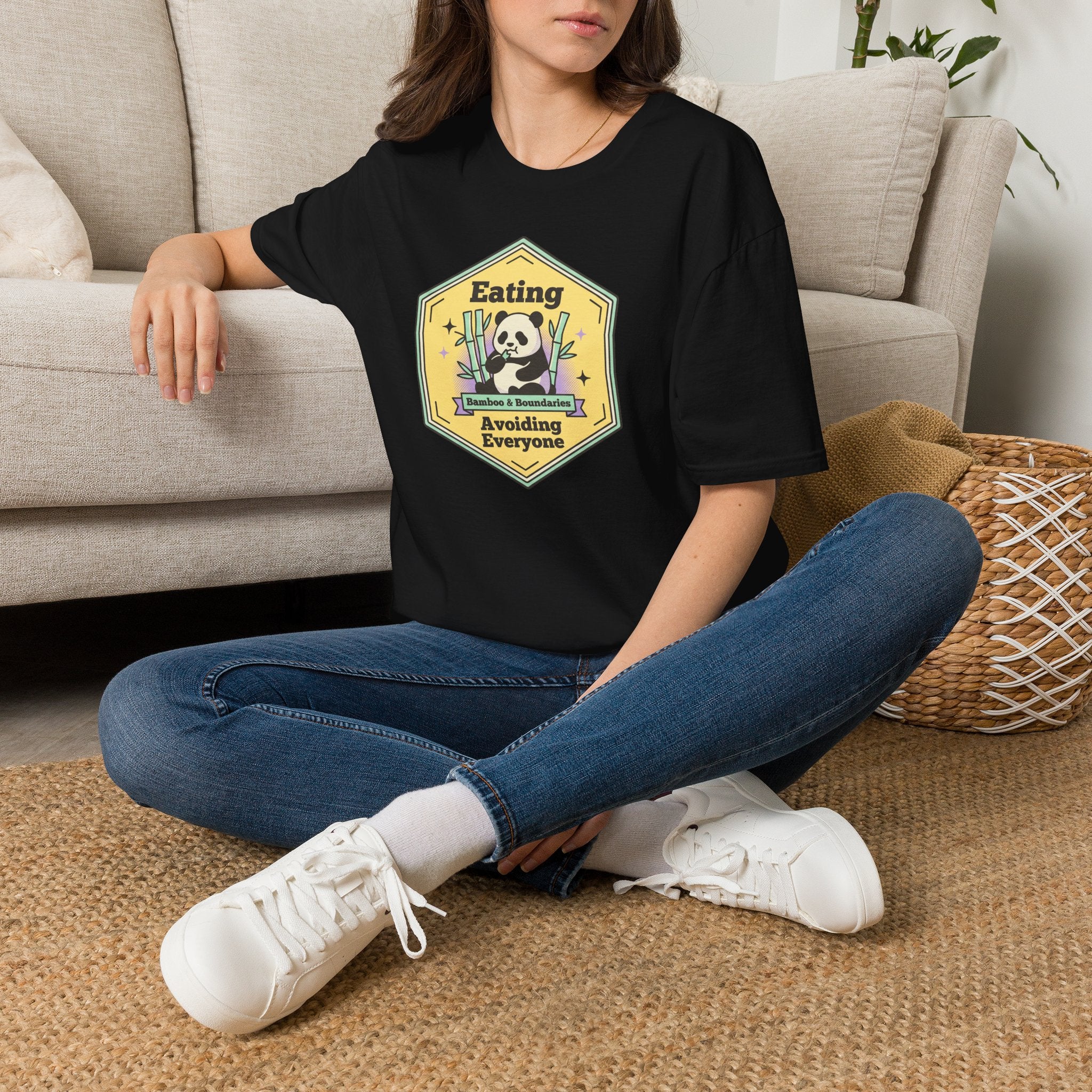 Unisex softstyle T-shirt in black worn by model with front graphic print