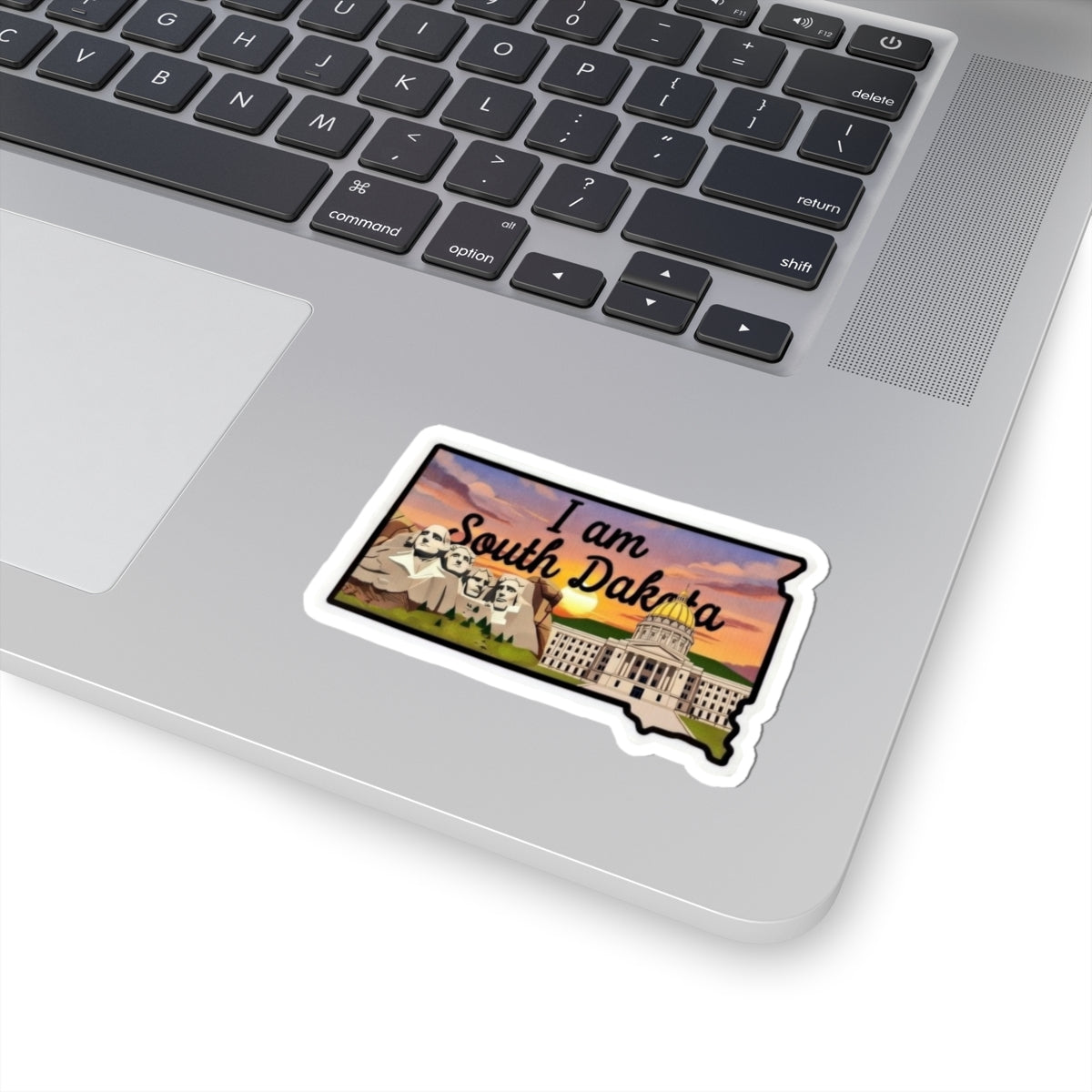 Die-cut sticker: “I am South Dakota” with Mount Rushmore and capitol building illustration