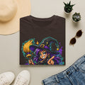 Dark brown T-shirt laid flat with colorful witch and candy graphic on the front