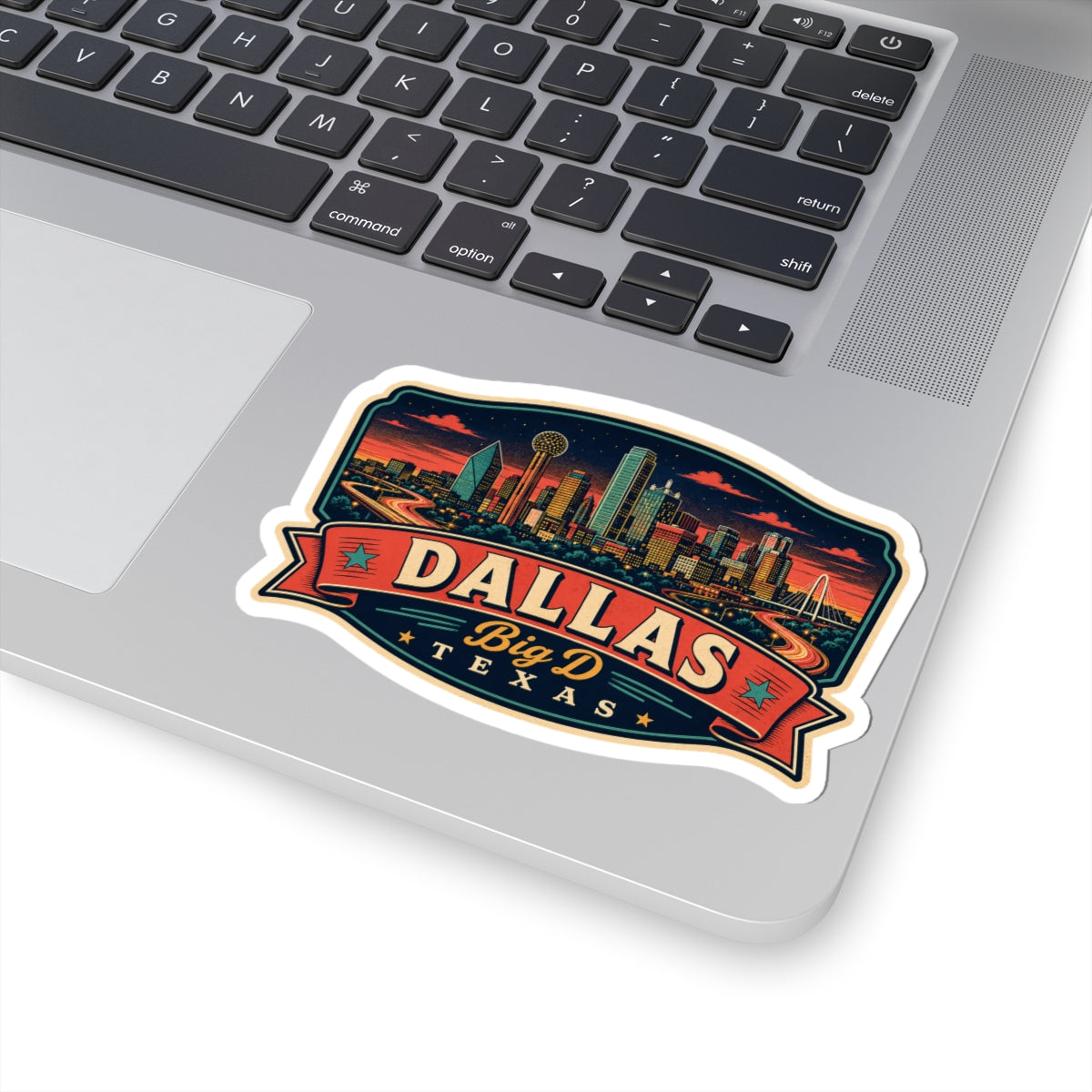 Dallas luggage tag sticker on laptop lid, teal skyline and Big D Texas lettering