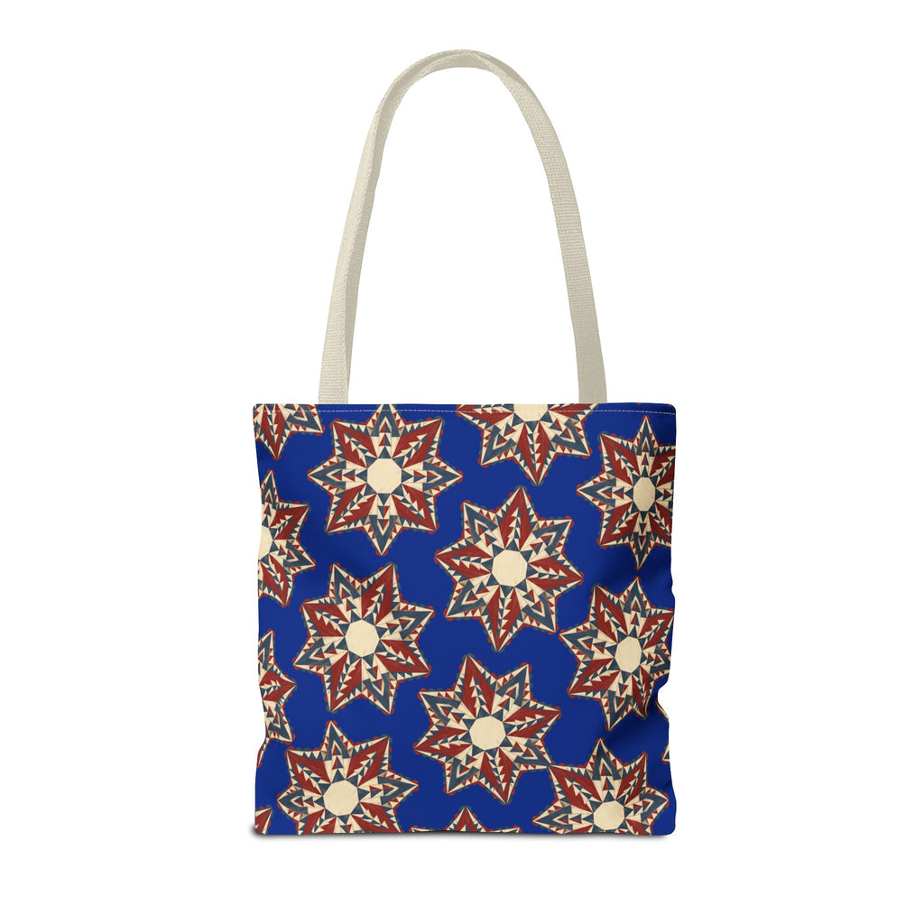 Blue square tote bag with starburst floral pattern in cream and red, long light handles