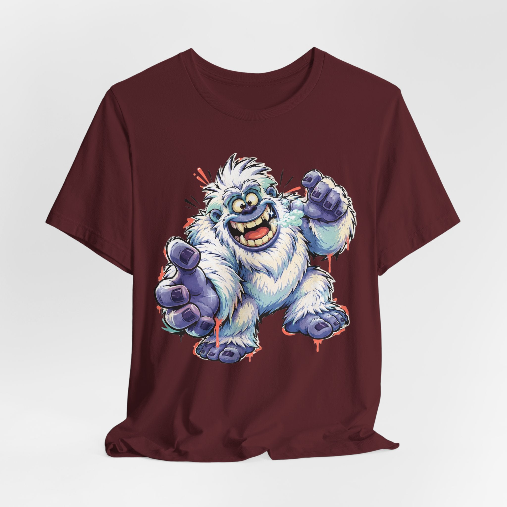 Burgundy crewneck T-shirt with cartoon snow monster illustration and blue raised hands