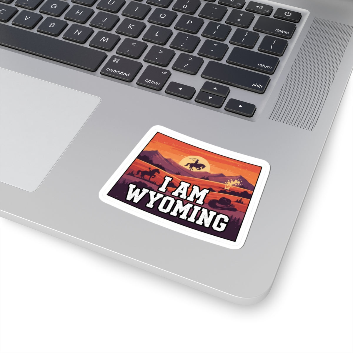 I Am Wyoming sticker on laptop, red sunset landscape and 'I AM WYOMING' lettering