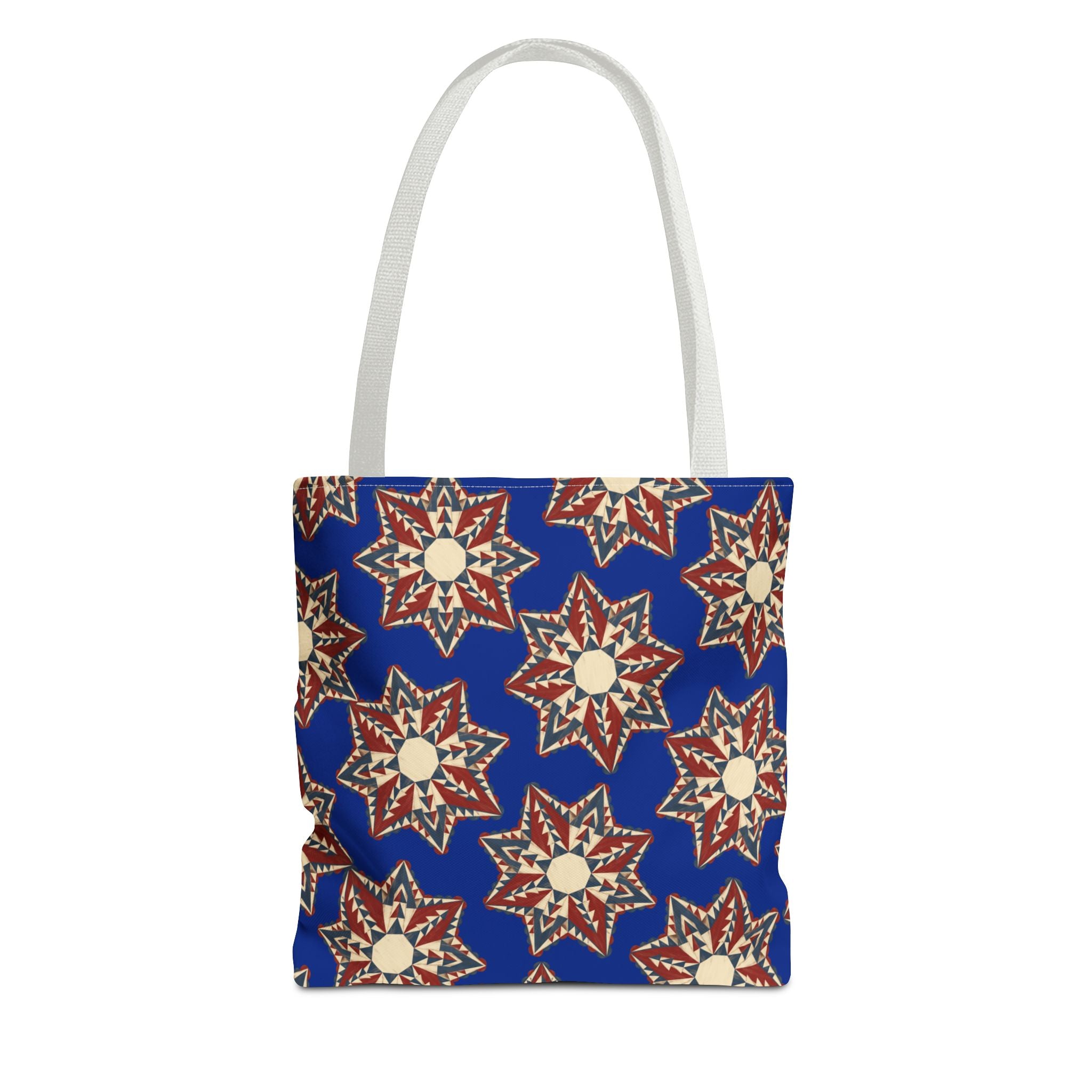 Blue tote bag with starburst floral pattern and light gray handles