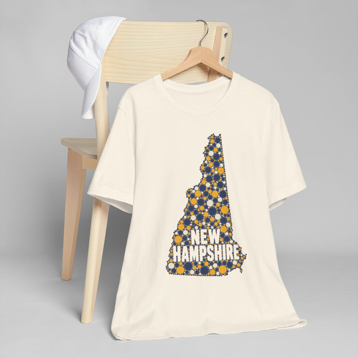 Natural T-shirt with blue and yellow tree graphic and New Hampshire text