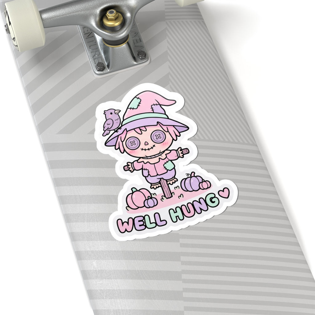 Pastel scarecrow bunny sticker with “WELL HUNG” text and heart beneath the character
