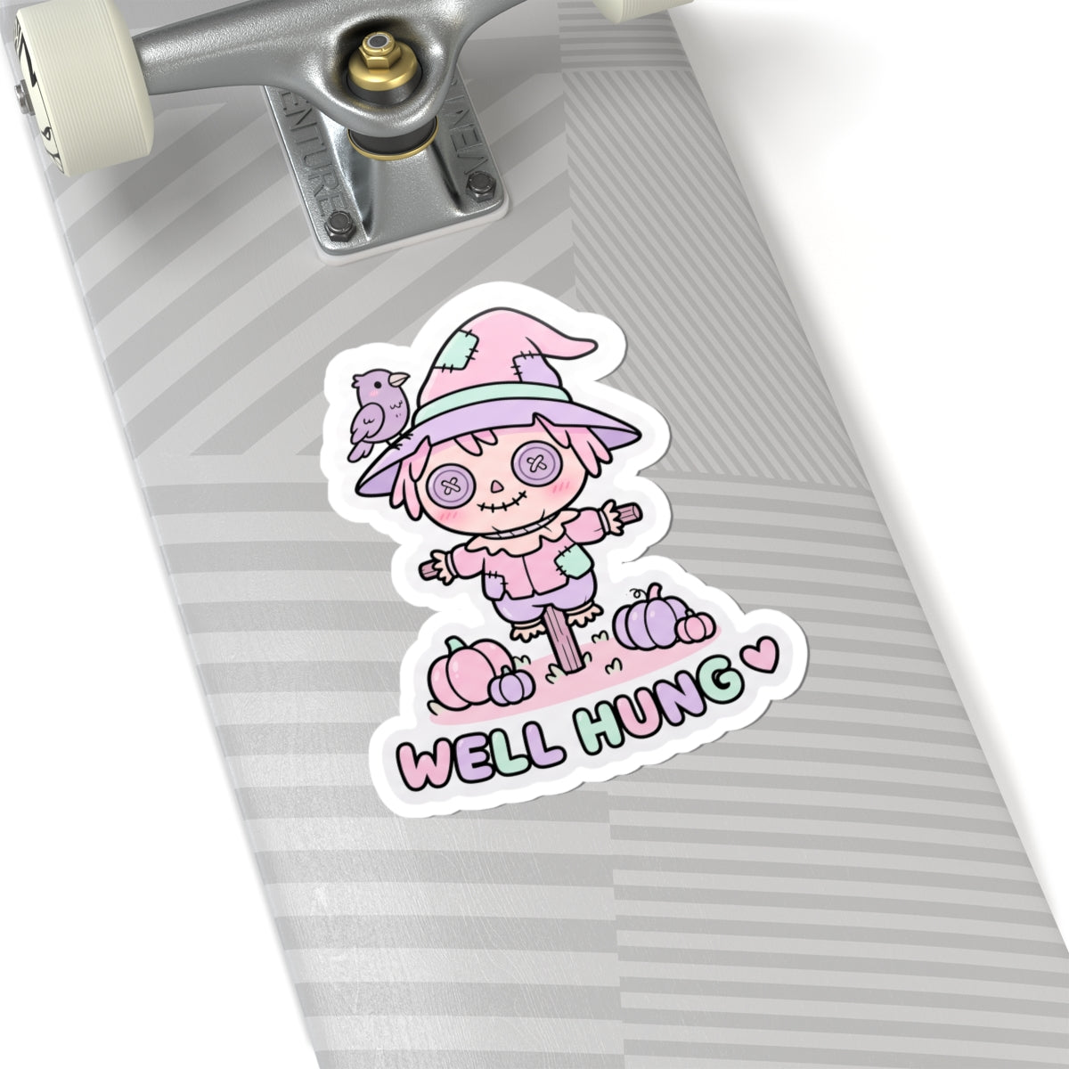 Pastel scarecrow bunny sticker with “WELL HUNG” text and heart beneath the character