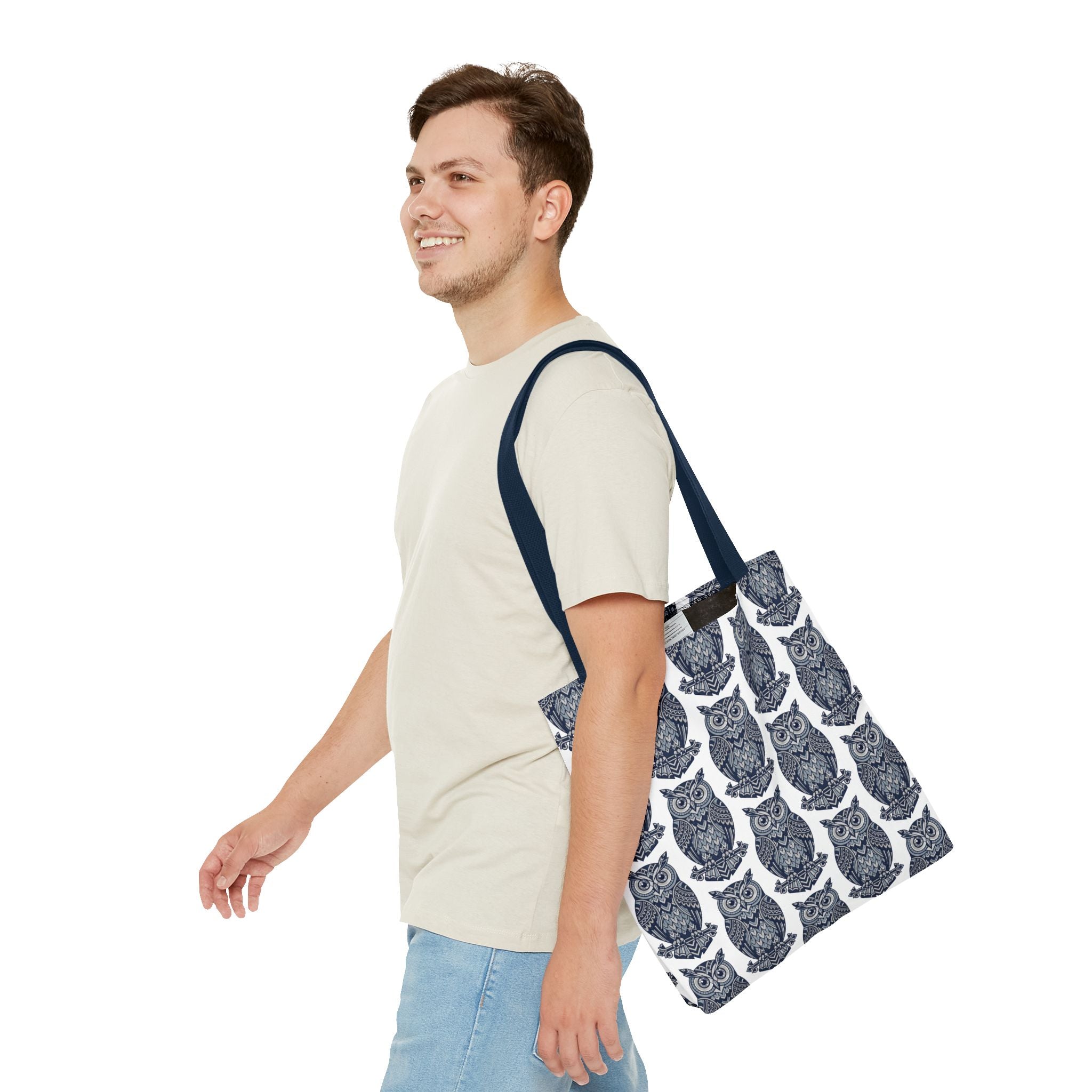 Owl-pattern tote bag with navy shoulder strap, held by a person, blue and white owls