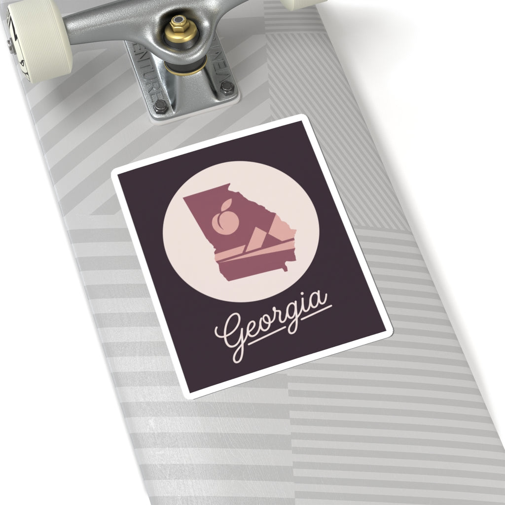 Mauve Georgia state silhouette vinyl decal with circular emblem and cursive Georgia script